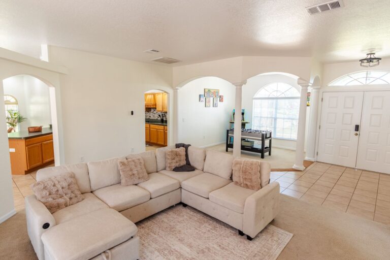 After: Michaels House family room with an oversized sectional and arched windows