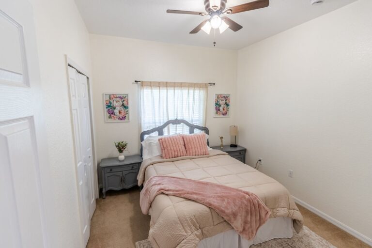 After: Michaels House guest bedroom with queen bed and coral accents