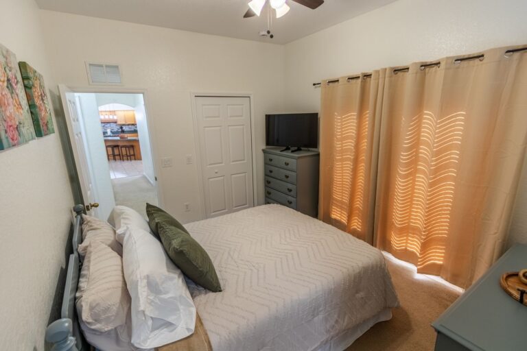 After: Michaels House guest bedroom with green accents and blackout curtains