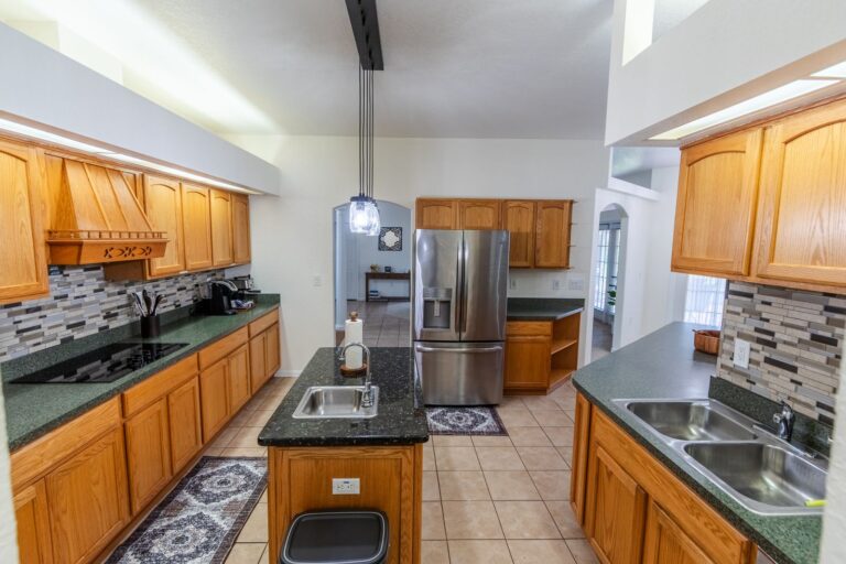 After: Michaels House kitchen with stainless appliances and tile backsplash