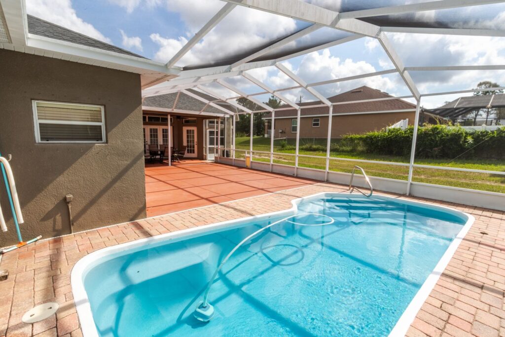 After: Michaels House screened pool with clear blue water and paver deck