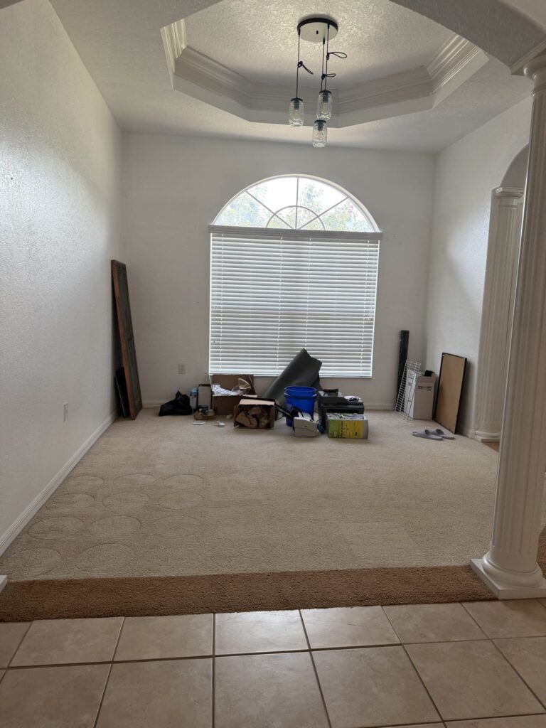 Before: Michaels House front room with arched window, empty during move-out