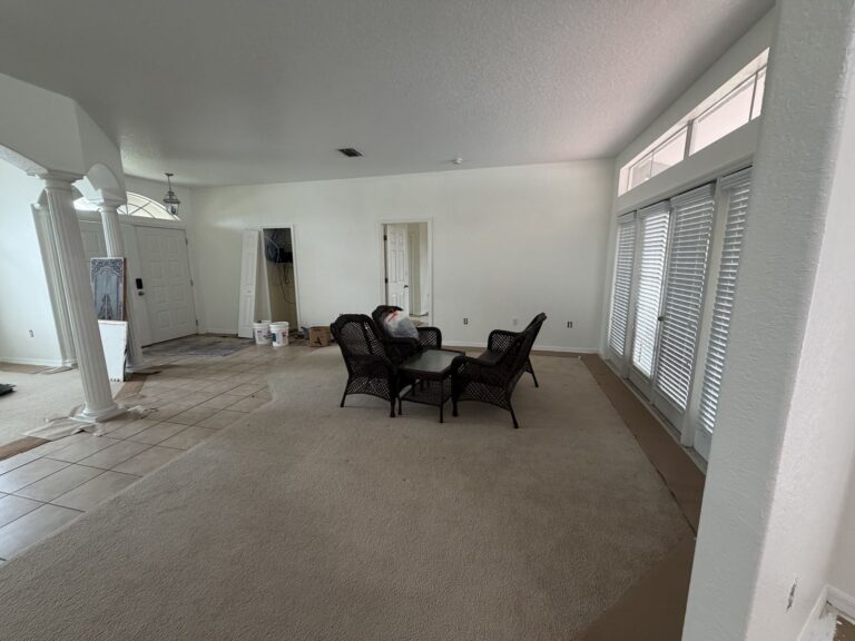 Before: Michaels House living room, mostly empty with worn tile and dated furniture, Hernando County FL