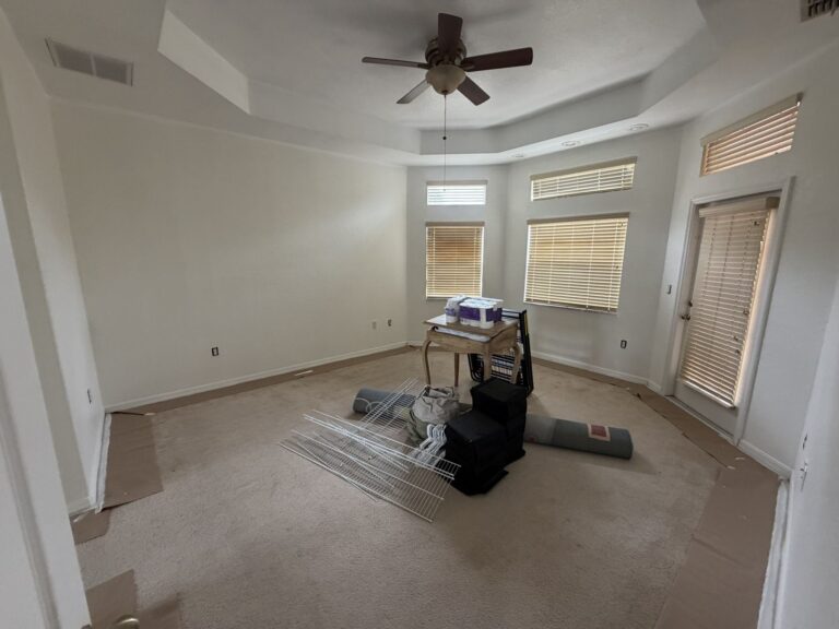 Before: Michaels House primary bedroom, empty with boxes on the carpet